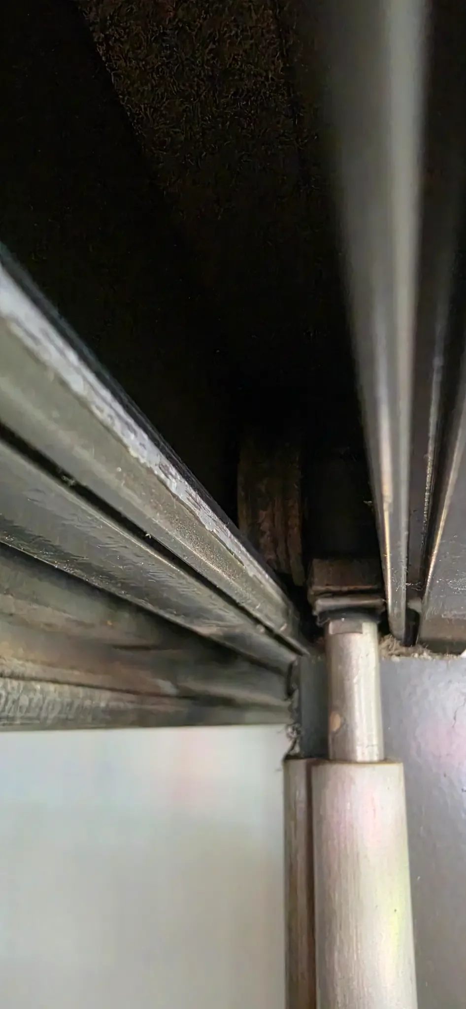 Sliding door roller being inspected
